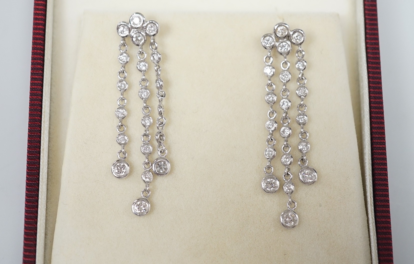 A modern pair of 750 white metal and diamond cluster set drop earrings, 42mm, gross weight 5.2 grams.